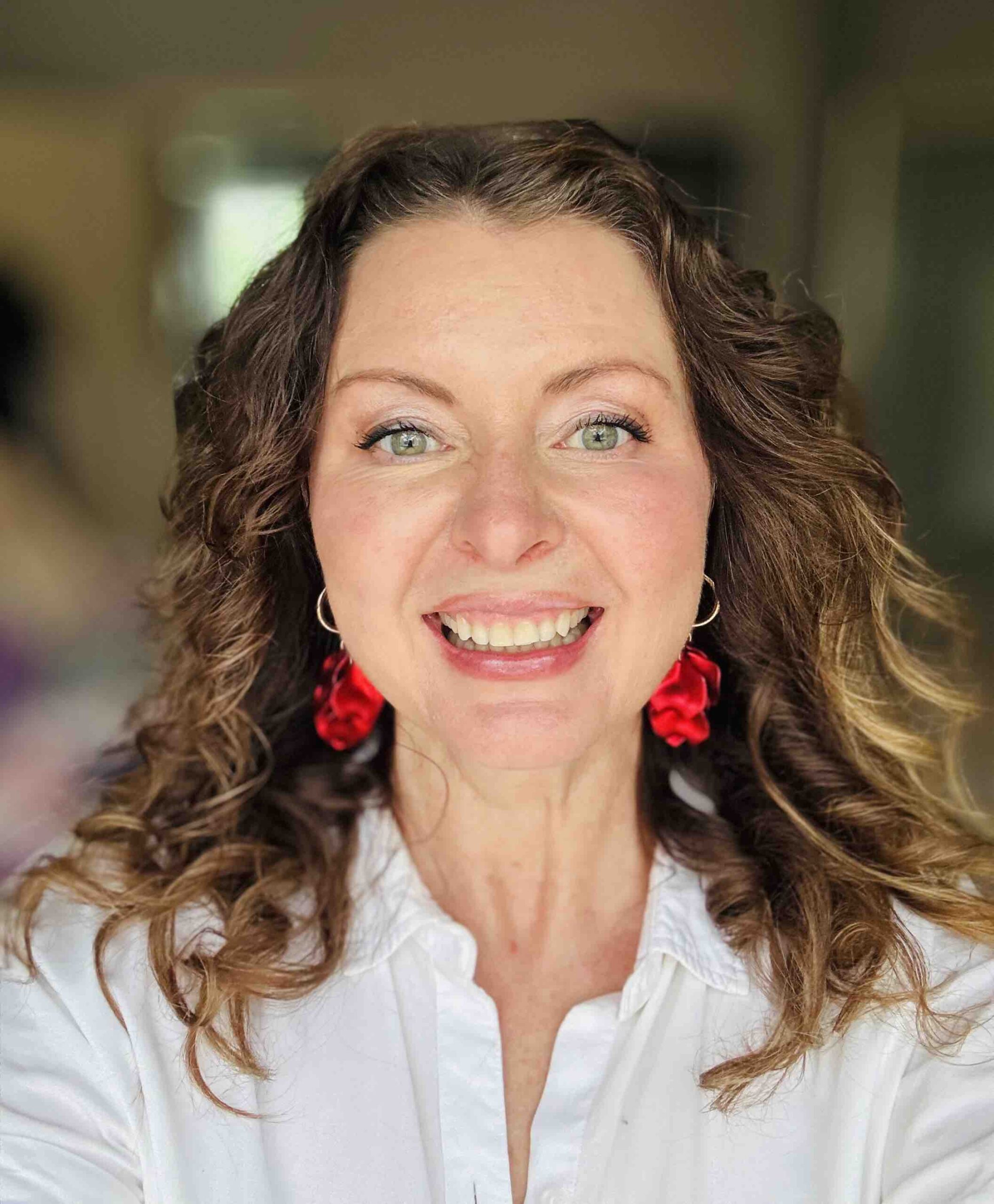Melissa Runacres, trauma-informed money mindset coach for creative entrepreneurs, smiling and standing indoors.